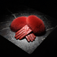 Red fur and leather gloves on a dark stone surface